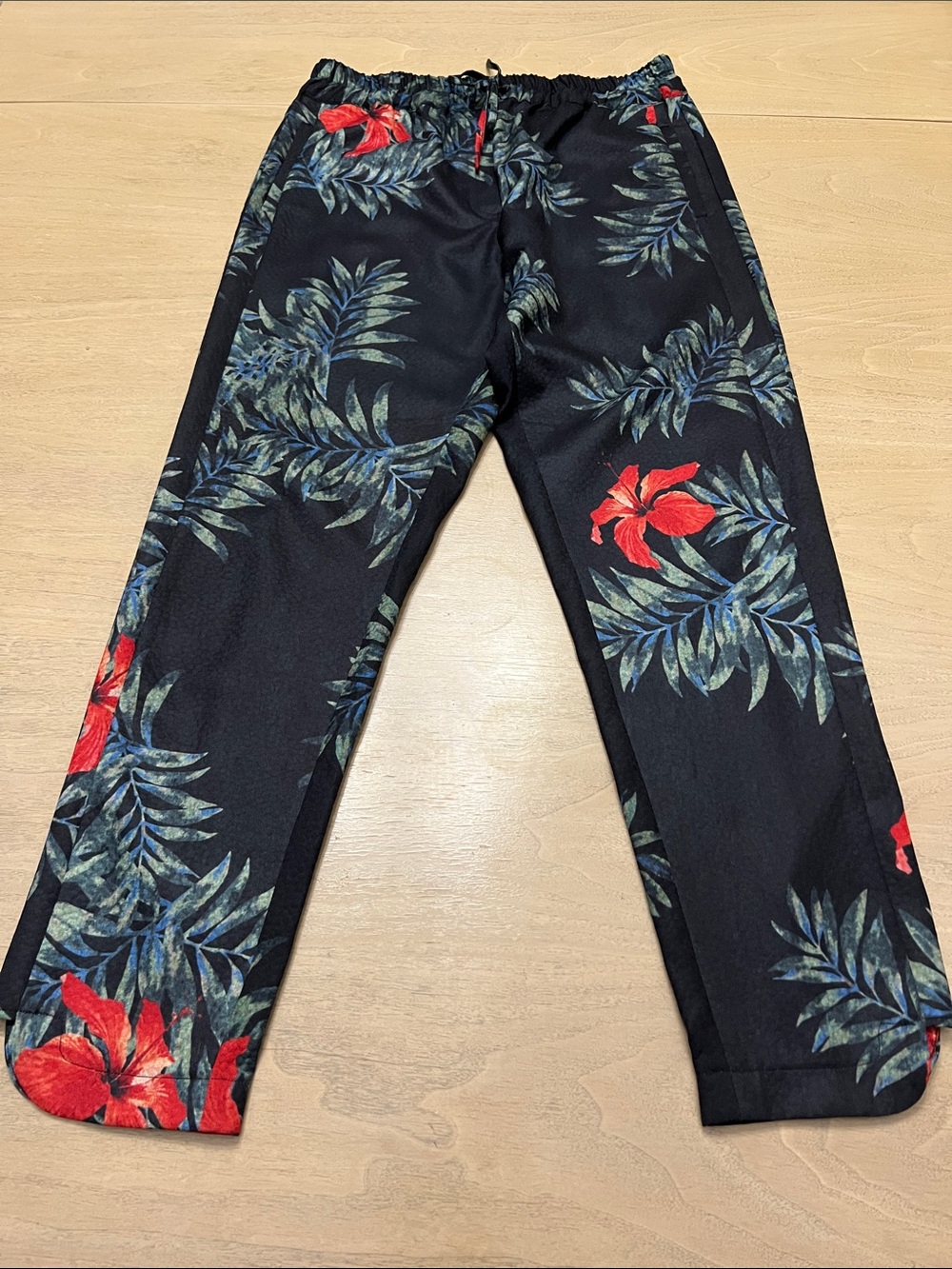 Surface to Air Black Floral Print Pants with Red & Green Accents